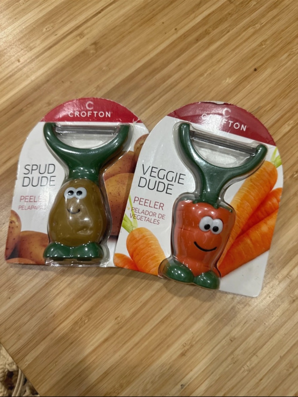 Crofton Peeler with Green Handles and Orange & Brown Characters. Choose 1